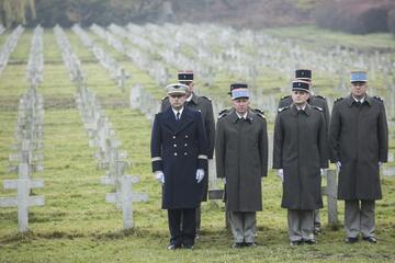 na zdjęciu ośmiu oficerów francuskich w oficjalnych wojskowych strojach, za nimi rzędy setek białych krzyży cmentarnych