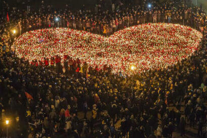 Zdjęcie przedstawia ogromne serce z prawie 30 tys. płonących zniczy na Pl. Solidarności w Gdańsku