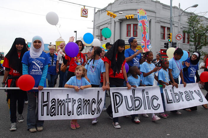 Darmowa wiedza dla wszystkich: młodzież z Hamtramck w czasie parady niesie transparent reklamujący publiczną bibliotekę